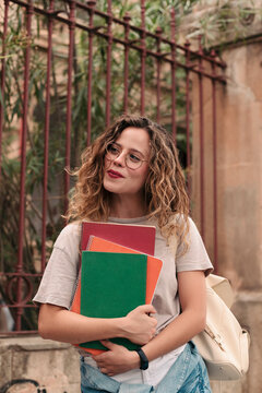 Female student carrying notebooks