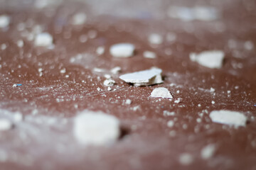 Defocus ruined rubble on brown background. Building debris close-up. Demolition of buildings and structures. Pieces of drywall, glass and steel beams. Ukraine war. Out of focus