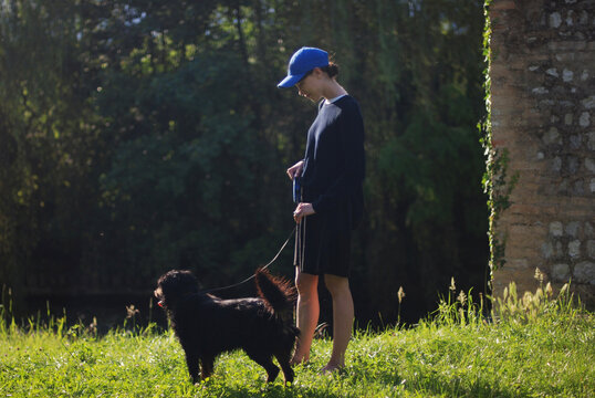 Young woman and her black dog in park