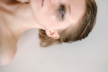 portrait of a beautiful fragile girl with a strong look close-up with unfolded shadows under the eyes