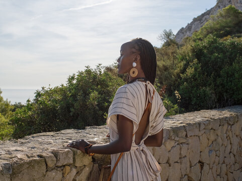 Black woman admiring sea from viewpoint