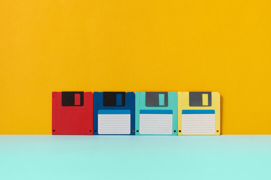 Four floppy disks standing over duotone background