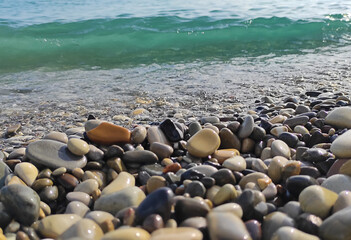 Pebble gravel sea stones natural beach background. Partly blurred out of focus.