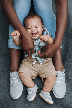 An Adorable Baby Laughs as His Mother Tickles his Belly