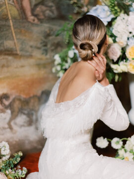 Bride With Turned Head Looking At Flowers
