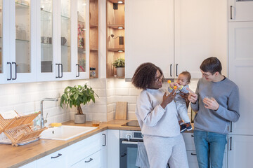 family lifestyle, happy couple with baby portrait in kitchen at home
