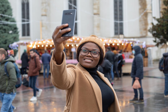 woman tourist doing selfie in Christmas market in France in Europe