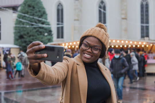 woman tourist doing selfie in Christmas market in France, Europe