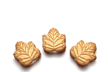 Delicious cookies filled with vanilla cream made with honey or maple syrup from Canadian trees, the traditional sweet of Canada on a white background	