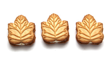 Delicious cookies filled with vanilla cream made with honey or maple syrup from Canadian trees, the traditional sweet of Canada on a white background	