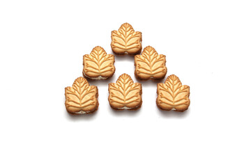 Delicious cookies filled with vanilla cream made with honey or maple syrup from Canadian trees, the traditional sweet of Canada on a white background	