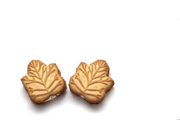 Delicious cookies filled with vanilla cream made with honey or maple syrup from Canadian trees, the traditional sweet of Canada on a white background	