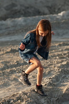 Girl dancing on sand in desert