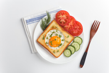 An egg sandwich and fresh vegetables for a healthy breakfast. Whole grain toast, fried eggs and organic microgreens on a white table.