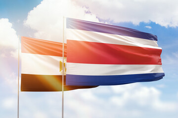 Sunny blue sky and flags of costa rica and egypt