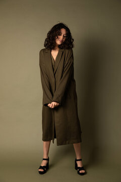 Elegant Model Stands in Front of Seamless Backdrop