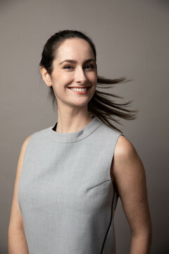 Elegant Woman Flips Hair In Front of Seamless Backdrop