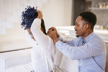 Husband helping beloved person with accessories 