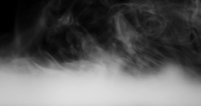 Rolling smoke clouds or swirling fog with wisps of vapor on black.