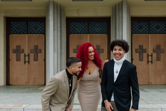 Pretty mom with happy sons in front of church