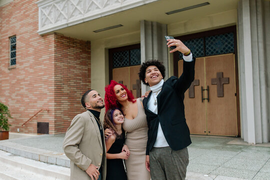 Happy family selfie on church steps