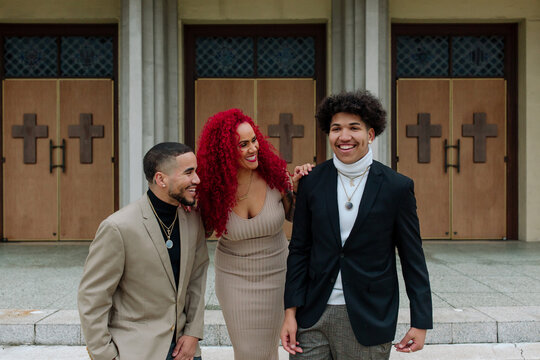 Laughing mom and sons in front of church