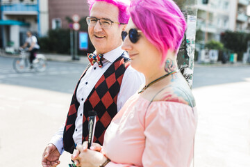 Pink haired couple enjoying the walk around town