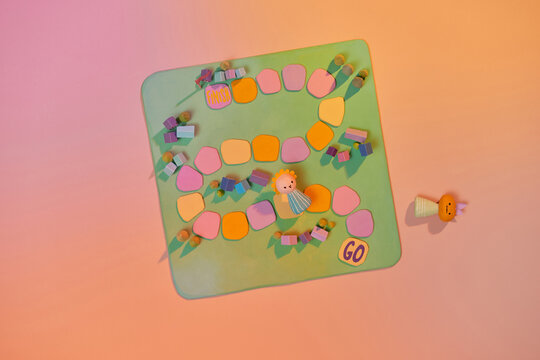 Colorful play figures with dice on board