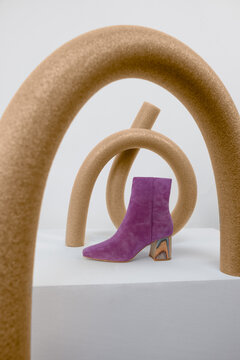 purple boot styled with brown sculptural props