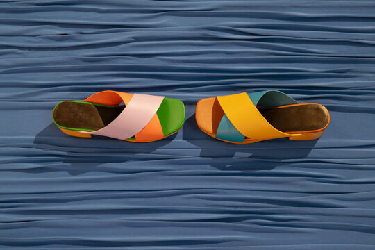 colorful summer sandals on blue fabric