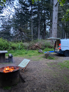 van set up at campground in the trees