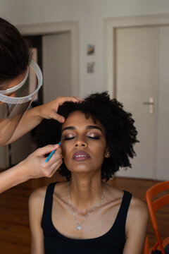 Professional make up artist with facial protection