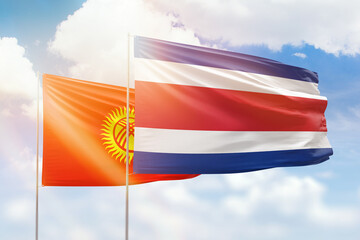 Sunny blue sky and flags of costa rica and kyrgyzstan