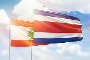 Sunny blue sky and flags of costa rica and lebanon