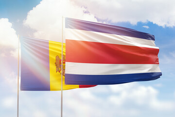 Sunny blue sky and flags of costa rica and moldova
