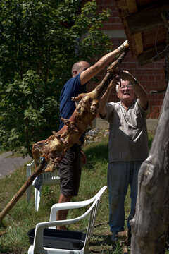 Candid scene of son and father during a 
Barbecue