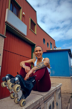 Portrait of a non binary model with rollerskates smiling