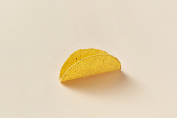 Freshly baked empty taco on beige background