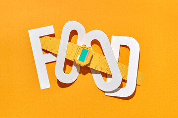 Papercraft work food and wrist watch on yellow background