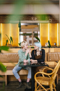 Women having cute moment during meeting in cafe