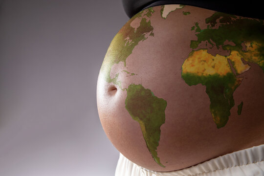 Pregnant with the map of the world drawn on her belly. Concept of pregnancy, motherhood, preparation, expectation, future and climate change.