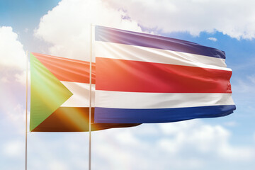 Sunny blue sky and flags of costa rica and sudan