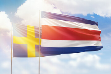 Sunny blue sky and flags of costa rica and sweden