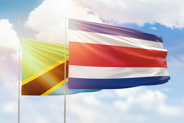Sunny blue sky and flags of costa rica and tanzania