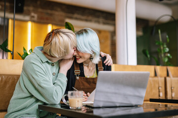 Woman showing her support to wife in cafe 