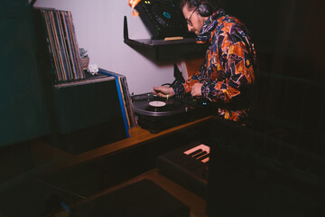 Dj plays with turntables at home