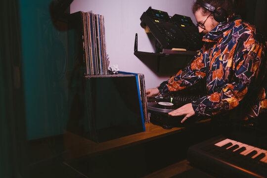 Man playing in his DJ studio