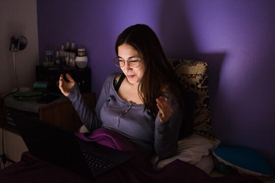 Woman reacting to conversation in video call