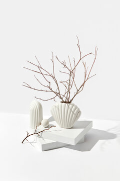 Ikebana in white ceramic vase