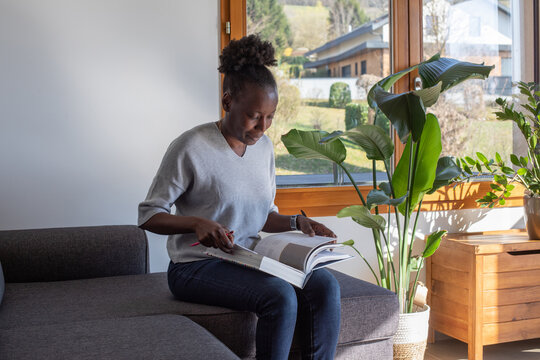 education, woman making a notes in big book at home